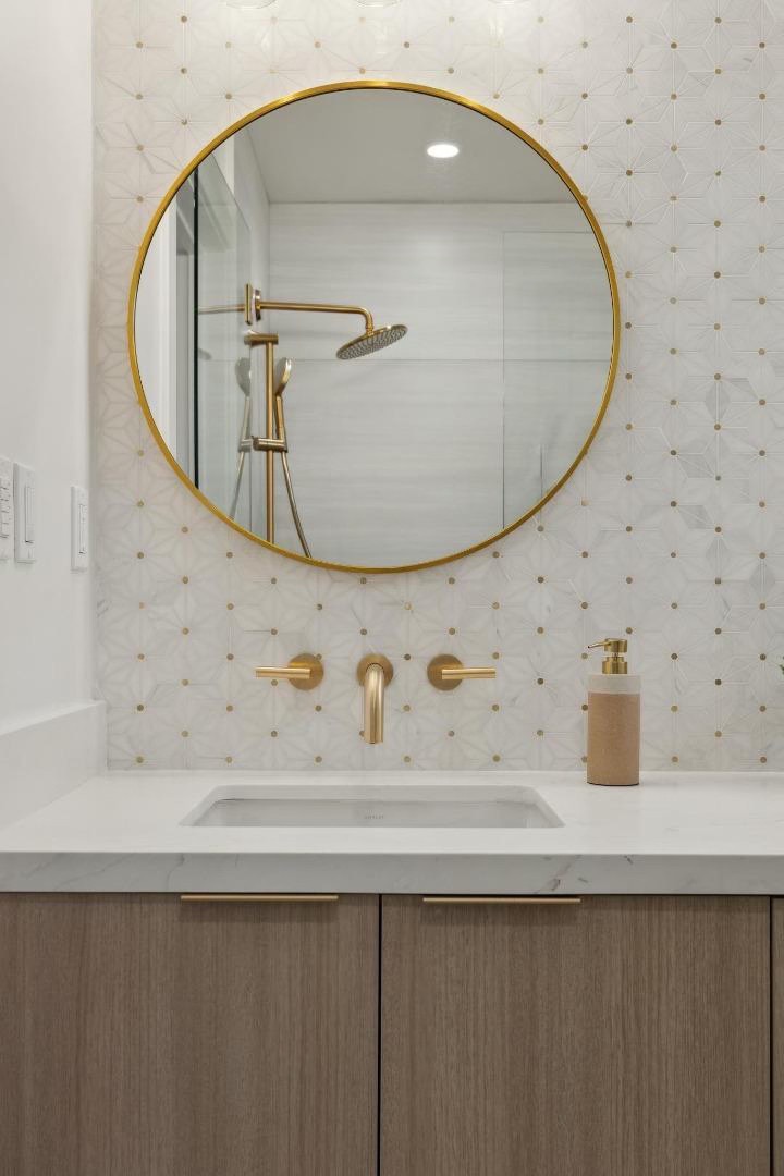 Bathroom vanity with round gold mirror