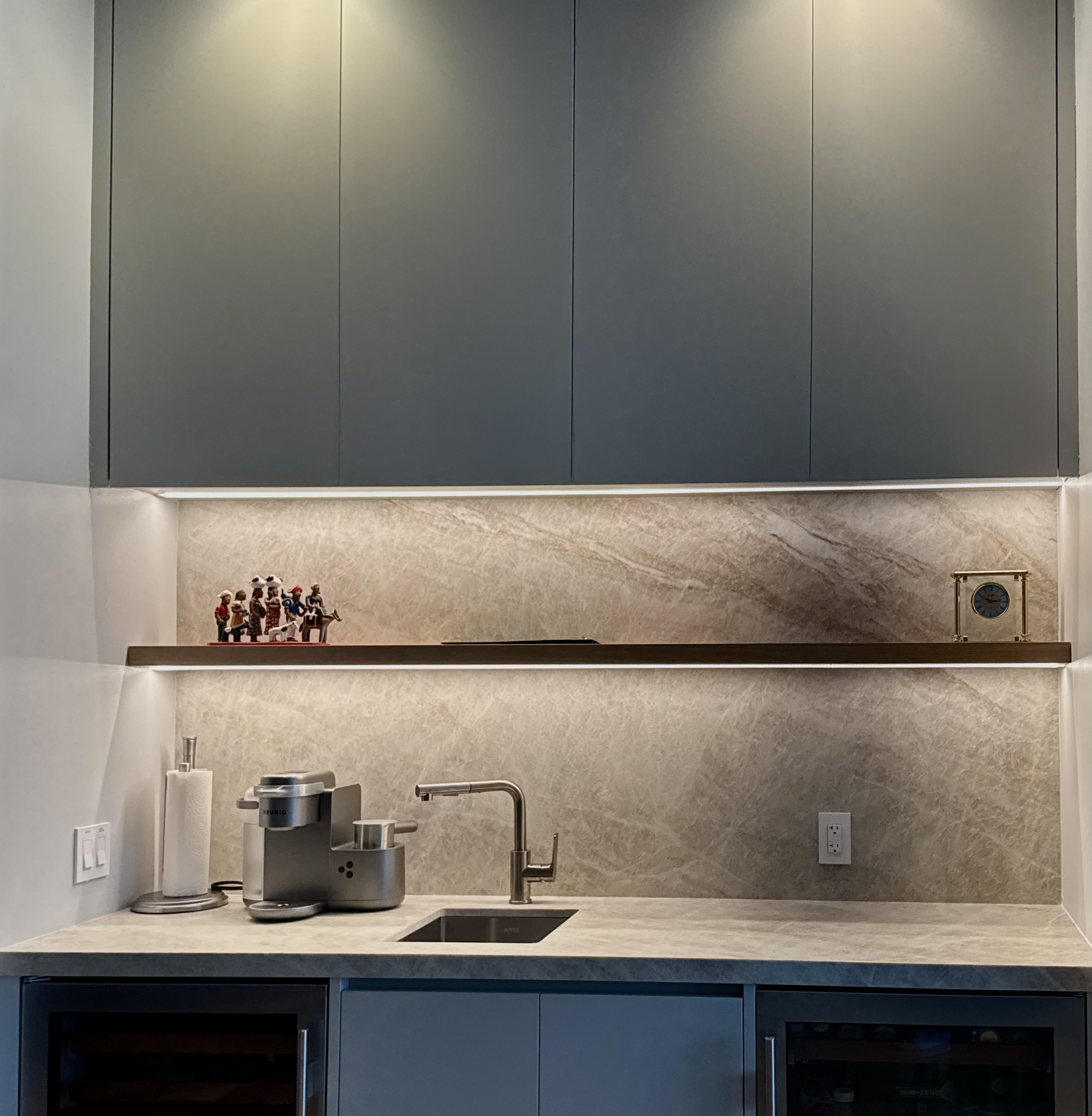 Moody bar with backlit stone backsplash