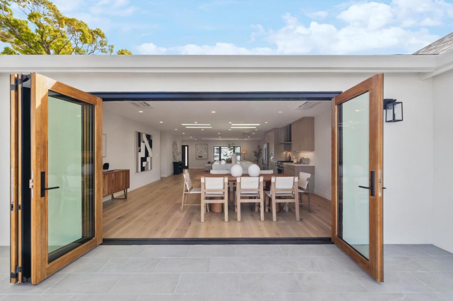 Dining room opening to the outdoors through folding doors